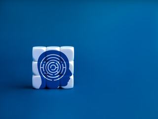 Maze game symbol in human head on completed white puzzle blocks on blue background with copy space....