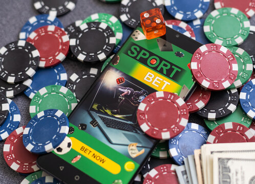 Online poker concept. Smartphone and poker chips on a green background. Poker online banner. Copy space. Vignette. Place for text. Gambling. Background.