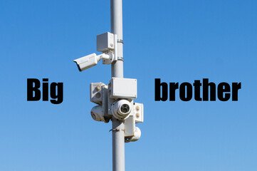 CCTV cameras on a street pole against a blue sky. The concept of total control and surveillance of...