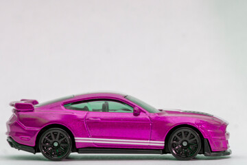 Toy violet sportcar on a white background
