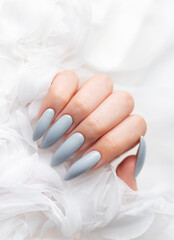 Grey nails on white lace background.