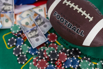 Gambling chips, soccer ball and dollar banknotes on a grey background. Gambling and betting concept
