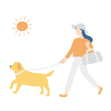 太陽を浴びて散歩する女性と犬