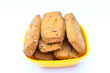 Salt Black cumin cookies in a bowl on white background close-up view 