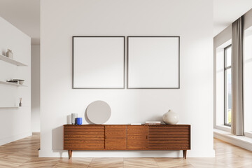 White living room interior with dresser and posters - obrazy, fototapety, plakaty