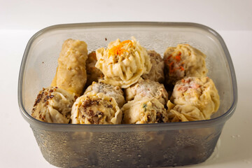 Frozen dimsum in container isolated on white background