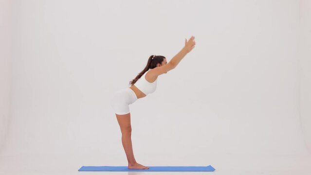 Fitness workout. Sporty Woman doing stretching on a white background slow motion