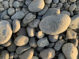 Smooth rocks on beach, Rounded pebbles in sun shine, sea side