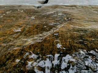 Wet rock on side of river, Rock wet with water