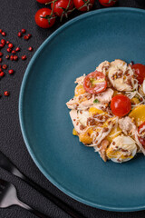 Delicious fresh salad with chicken, quail eggs, cherry tomatoes, lettuce