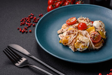Delicious fresh salad with chicken, quail eggs, cherry tomatoes, lettuce