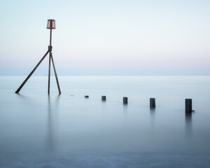 A calming long exposure shot of the sea and groynes