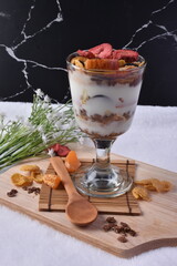 Delicious Dessert with Yogurt and Cream, Fruits, and White Flower Prop