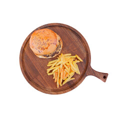 Cheeseburger and French fries on a round wooden board, top view, isolated on white background with clipping path