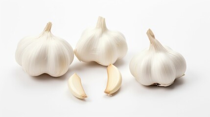 Obraz na płótnie Canvas Three stacks of garlic bulbs arranged on a white background, AI-generated.