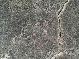 Grungy wall of gray concrete texture with cracked surface from sand and cement materials.