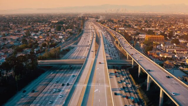 Top view drone rising above incredible complex highway junction in Los Angeles. Aerial Shot of Los Angeles Downtown. 