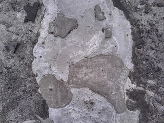 Grungy wall of gray concrete texture with cracked surface from sand and cement materials.