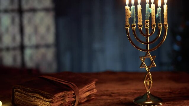 Old book and candlestick on Hanukkah night atmosphere