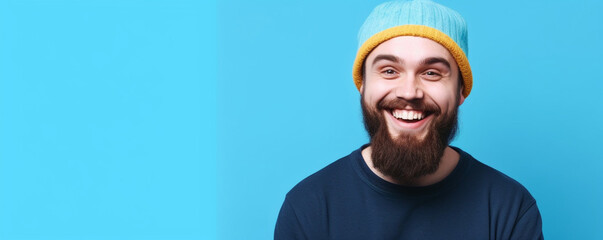 A pleased smiling young american man look at camera, Cheerful optimistic bearded guy, aside charming smile isolated on blue color background studio portrait happy People lifestyle concept