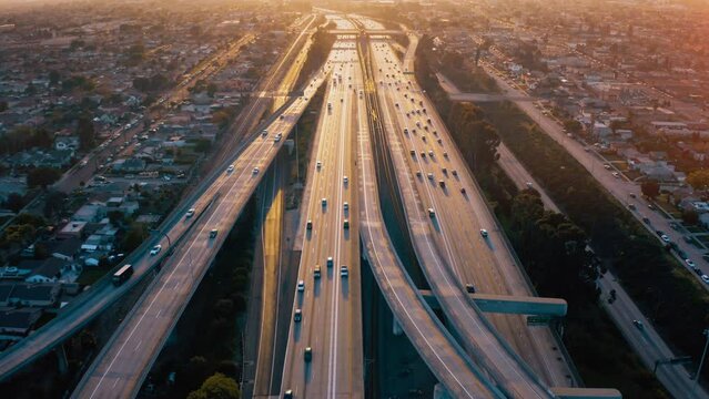 Top view drone rising above incredible complex highway junction in Los Angeles. Aerial Shot of Los Angeles Downtown. 