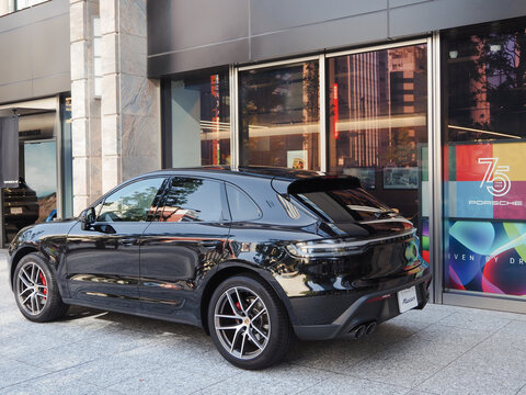 TOKYO, JAPAN - November 3, 2023: A Porsche Macan parked in front of a Porsche showroom in Tokyo's Nihonbashi area.