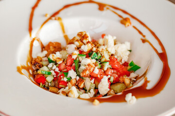 Salad with walnuts tomatoes and cheese, close-up, selective focus