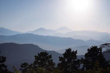 View of mountain layers includes Mt. Fuji from the top of Mt. Takao in Tokyo, Japan.
