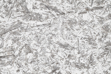 Chipboard plywood painted with white paint rough, surface close-up, uniform texture background