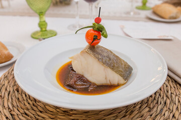 Confit of codfish loin topped with cherry tomato brochette
