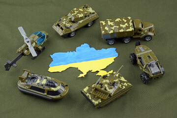 A battle tank with the Ukraine flag on a background of US dollar banknotes.