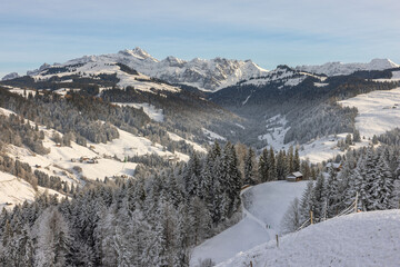 Fototapeta na wymiar A snowy winter landscape in the Swiss mountains on a beautiful sunny day.