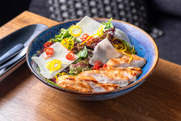 Healthy organic Chicken Caesar Salad. Caesar Salad with grilled chicken on plate.