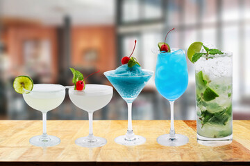 Five colorful cocktails on the bar counter Celebrate success, holiday, luxury, blurred background.