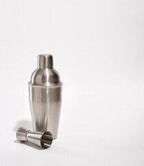 Luxury celebration party. Shiny metal shaker and jigger. Copy space for text. Making alcoholic cocktails at the disco.