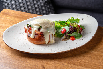 Eggs Benedict- toasted English muffins, ham, poached eggs, and delicious buttery hollandaise sauce