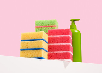 Stacks of colorful dishwashing sponges and a green gel dispenser. Cleanliness.