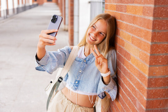 Girl taking selfie photo with a phone