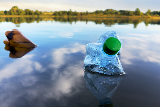 Marine plastic pollution from human activities at coastlines. Plastic waste in lake. Microplastics in groundwater. Ocean pollution and marine debris. Litter such as plastic from food in water of river