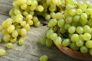 Delicious fresh green grapes on wooden table, closeup