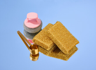 Metal abrasive sponges for dishwashing and cleaning. Coffee spoon on the mirror.