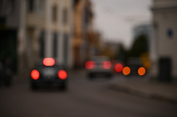 evening city street in the light of headlights and lanterns blur background