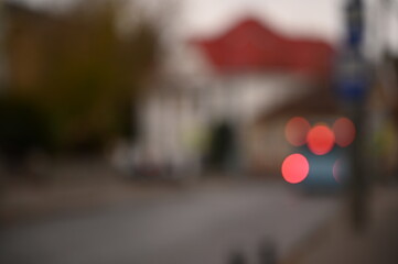 evening city street in the light of headlights and lanterns blur background
