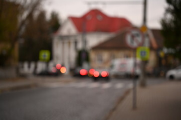 evening city street in the light of headlights and lanterns blur background