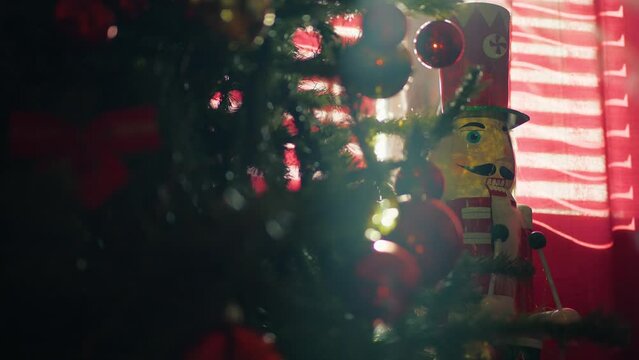 Silhouette of Christmas tree and nutcracker against red curtains of Hotel