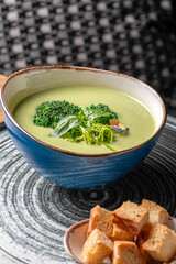 Fresh broccoli cream soup in bowl. Selective focus