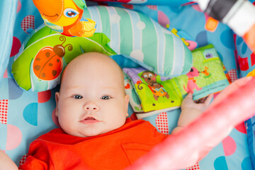 Portrait of cute baby a newborn girl playing in the room