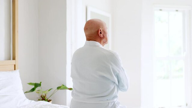 Thinking, bed and senior man back at a retirement and nursing home with depression and grief from memory. Mental health and elderly male person remember with anxiety and problem from dementia
