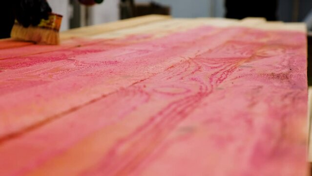 Treating the board with a red protective solution. Selective focus.