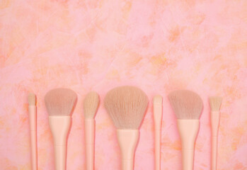 A variety of makeup brushes. Copy space for text, top view. Makeup, skin care concept.